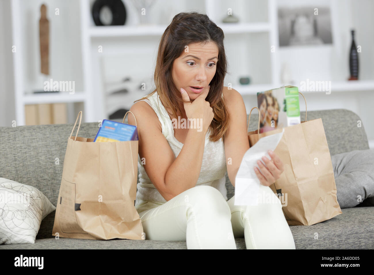 shocked woman after shopping at the supermarket Stock Photo