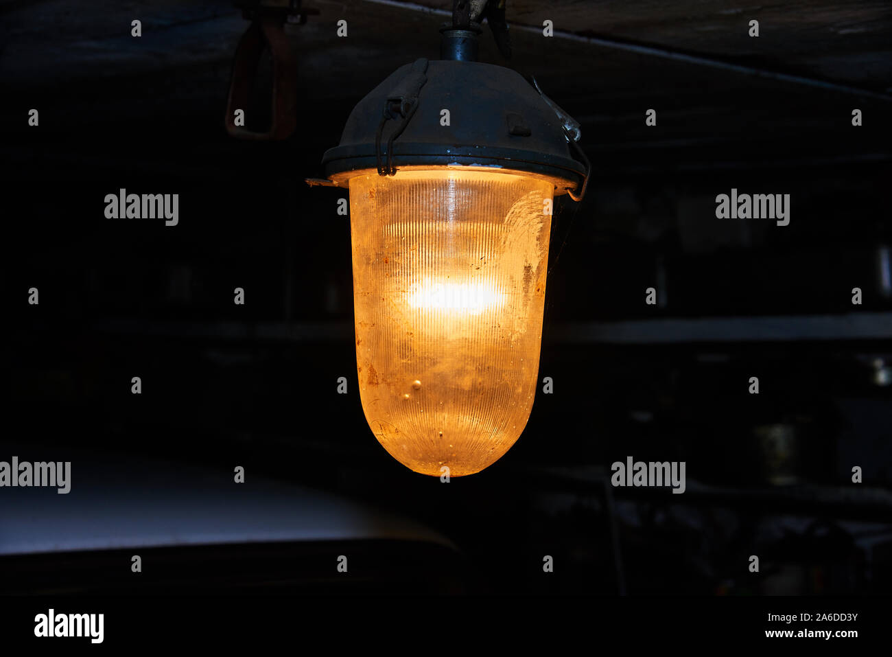 Old yellow lantern under the ceiling in the dark Stock Photo