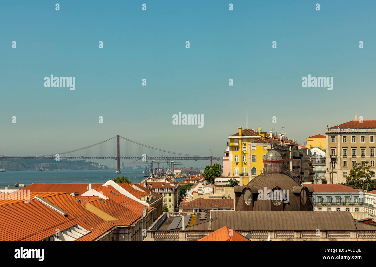 Colorful buildings and a view of the Ponte 25 de Abril and Tagus River in Lisbon, Portugal. Stock Photo