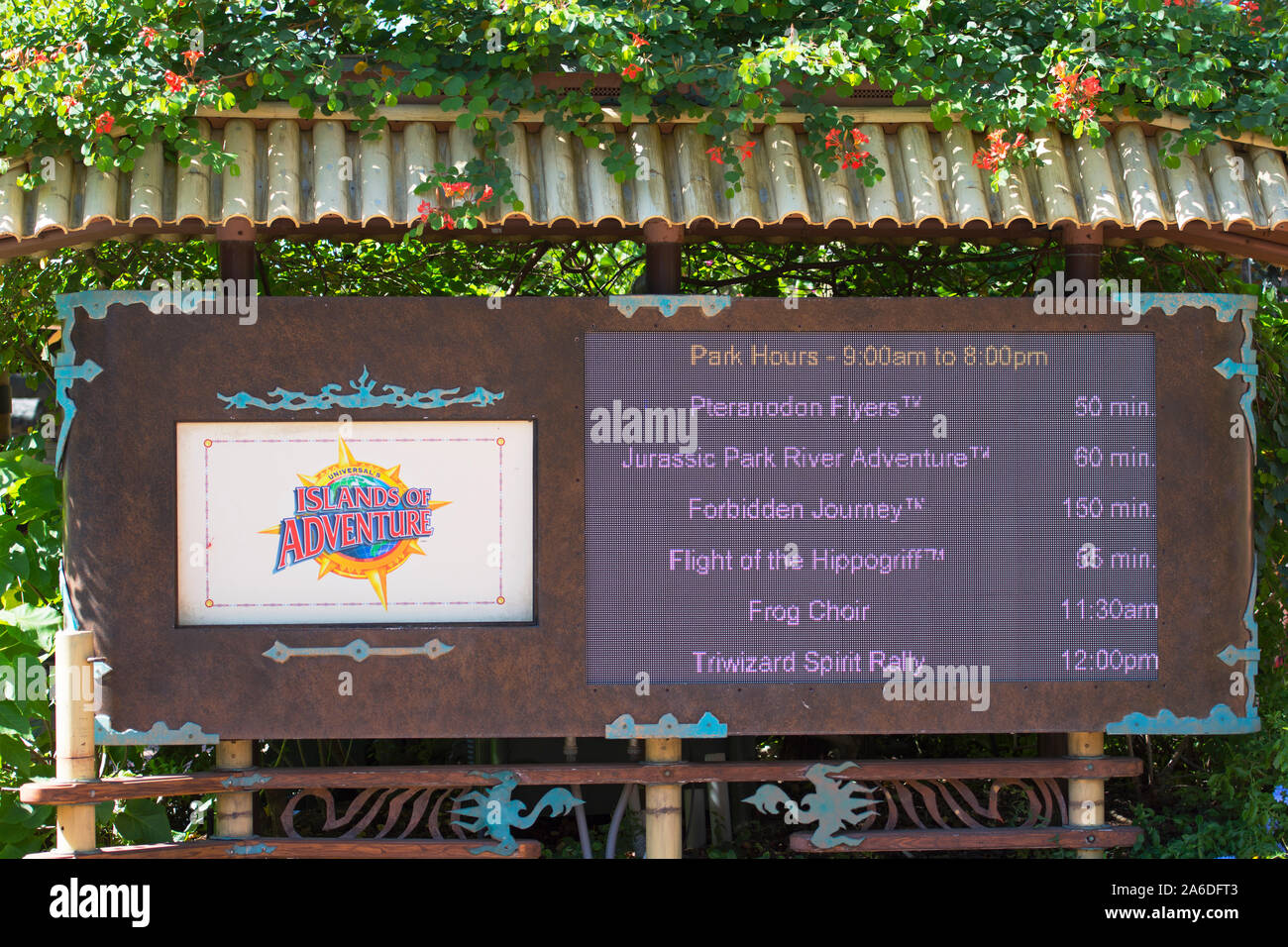 Universal Studios Sign Park Hours and Attraction and Ride Wait Times Posted, Islands of Adventure, Orlando, Florida, USA Stock Photo