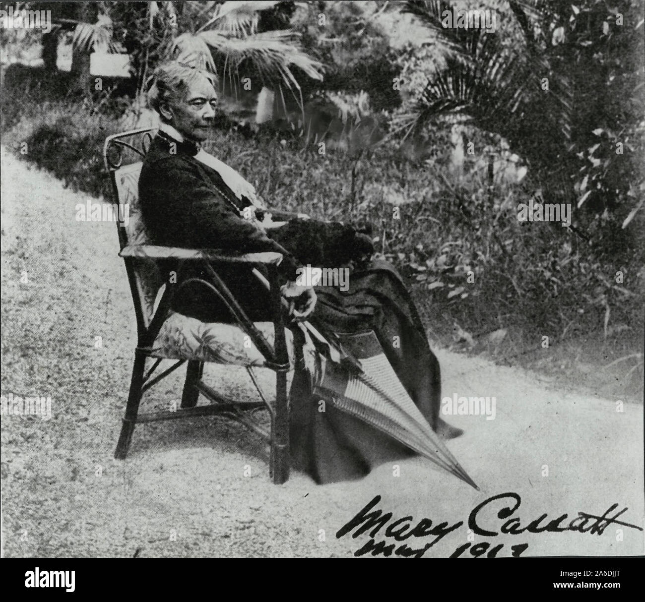Mary Cassatt seated in a chair with an umbrella. Verso reads - The only photograph for which she ever posed. 1917 Stock Photo