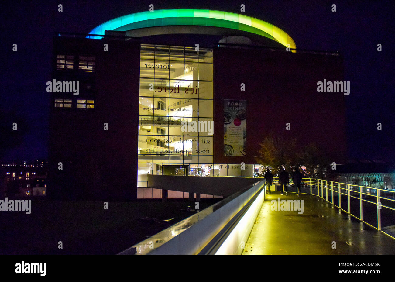 Night view of the exterior of the AROS Museum with its landmark coloured glass walkway atop the building. Stock Photo