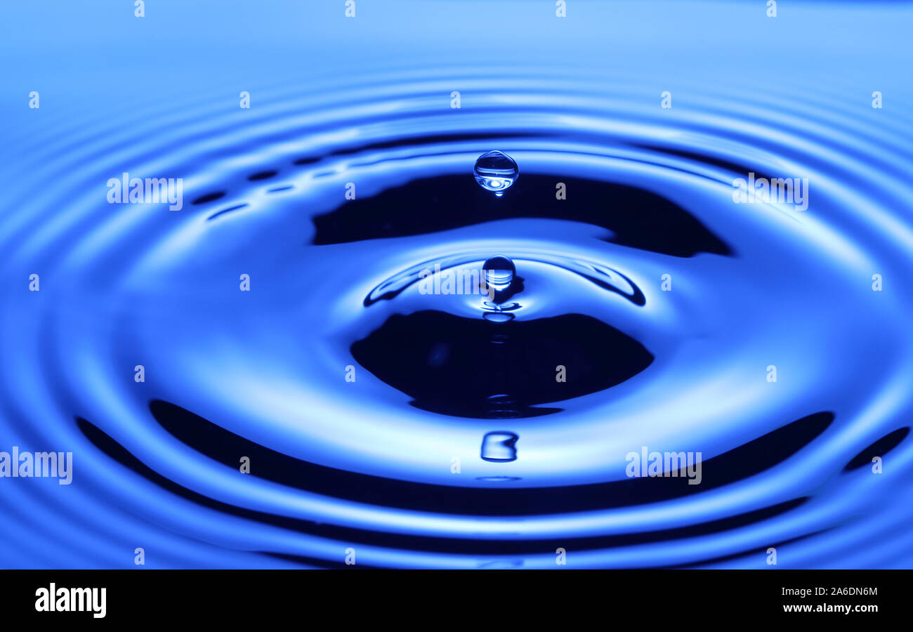 Splash of drop water in blue tone, blank spce from above to create concepttual. Stock Photo