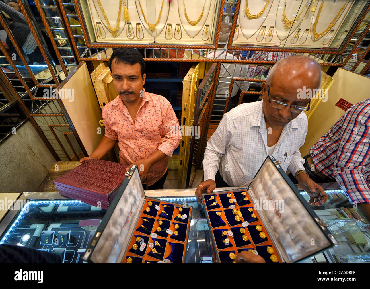 Kolkata, India. 25th Oct, 2019. Gold Traders display different Golden ornaments to the Customers during the Dhanteras festival day in Kolkata.Dhanteras is the most auspicious occasion for buying gold as per Hindu mythology & it is believed that it will bring good fortune for the buyer, as a result demand for the Golden jewellery is higher during this time. Credit: SOPA Images Limited/Alamy Live News Stock Photo