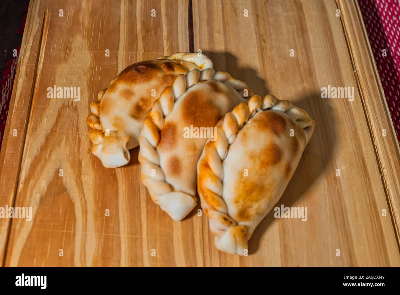 Wooden table with fresh homemade Empanadas (detailed closeup shot