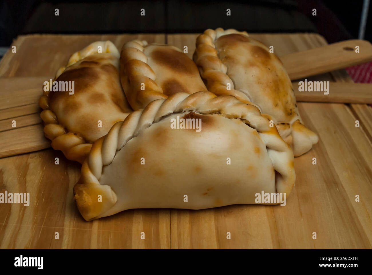 Wooden table with fresh homemade Empanadas (detailed closeup shot