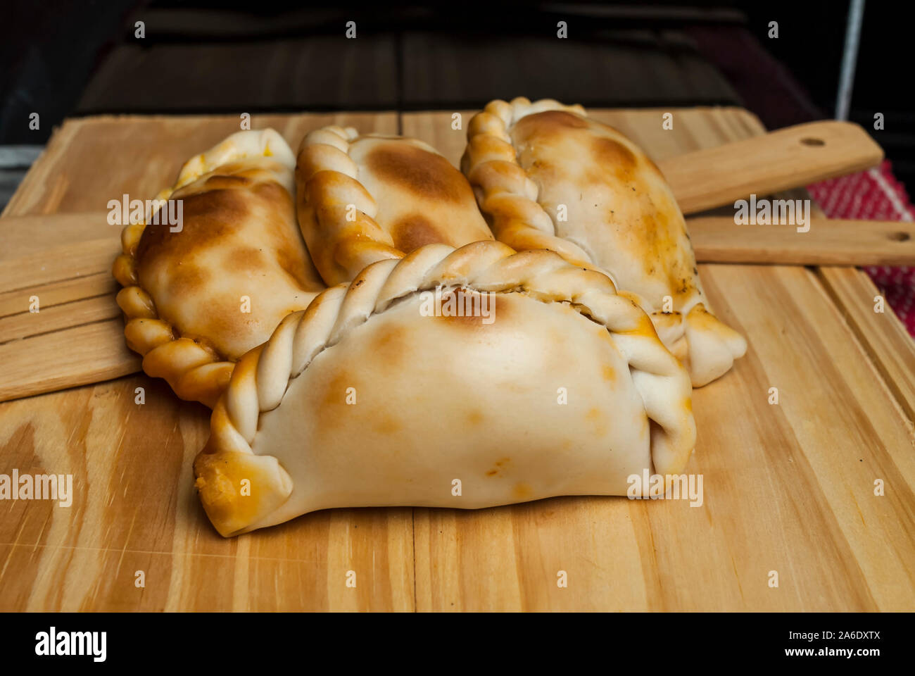 Wooden table with fresh homemade Empanadas (detailed closeup shot