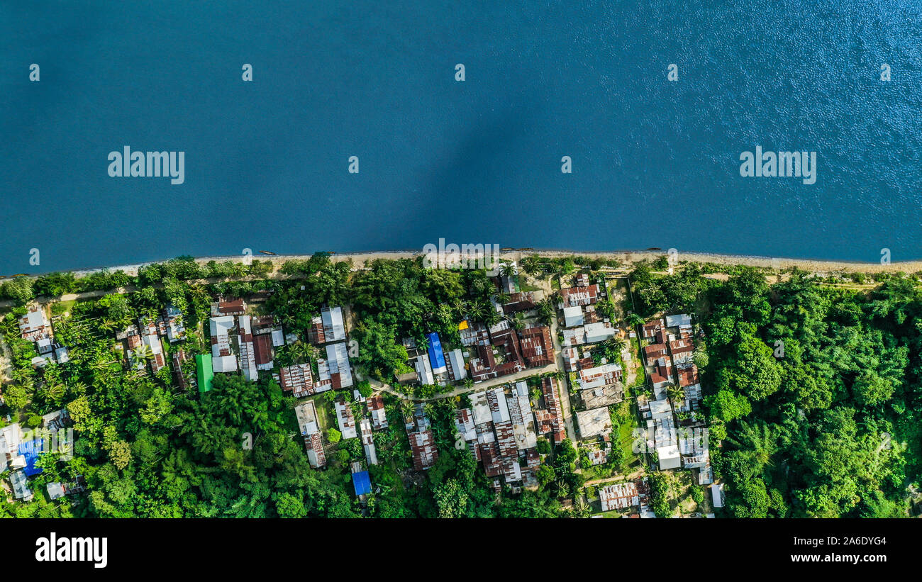 Drone shot over the Brahmaputra River And Suwalkuchi town (Also known as the SIlk City) of Assam, India. Stock Photo