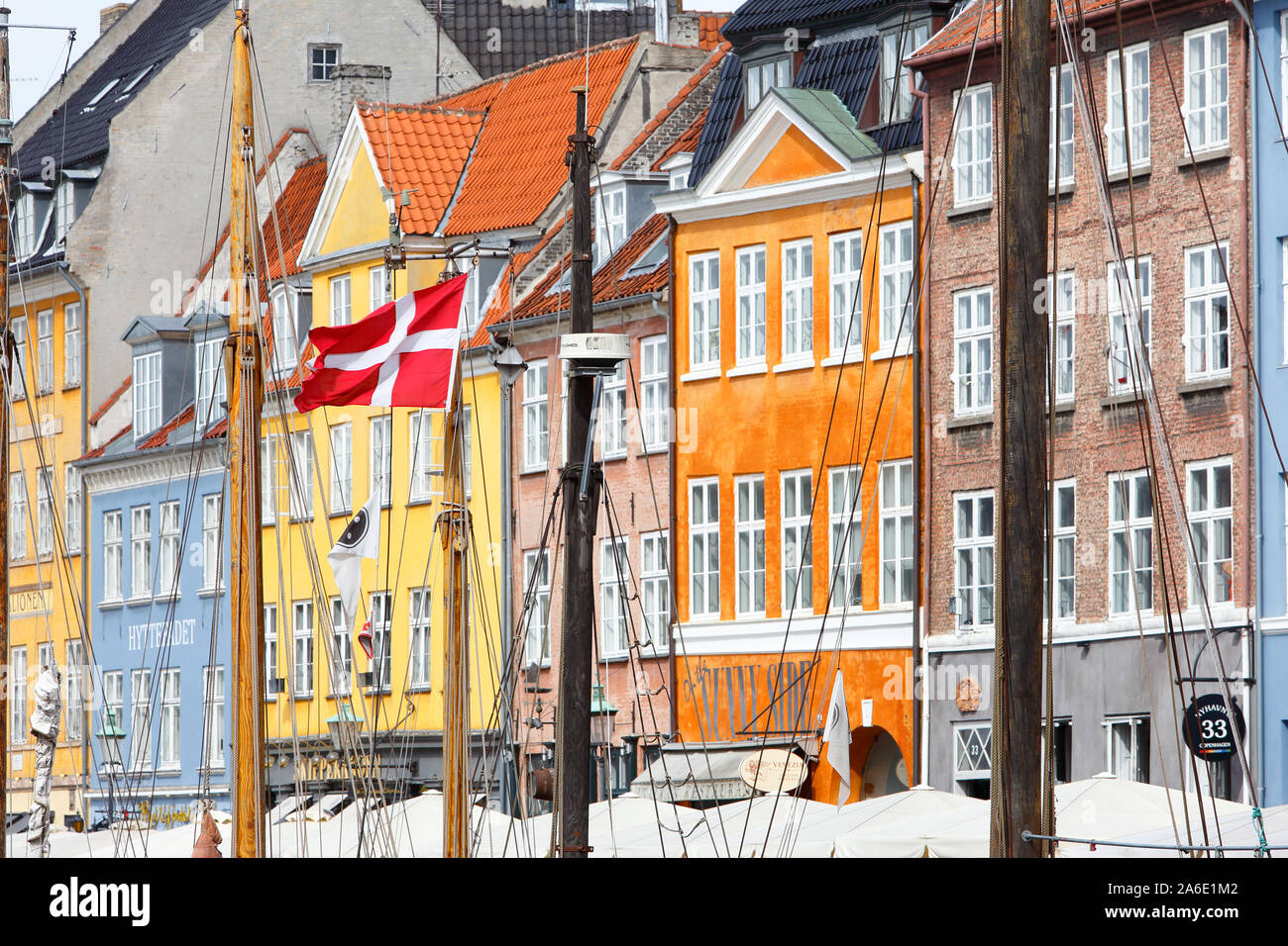 Copenhagen, Denmark - September 4, 2019: Dansh flag in one of the ships masts in the Nyhavn harbor area. Stock Photo