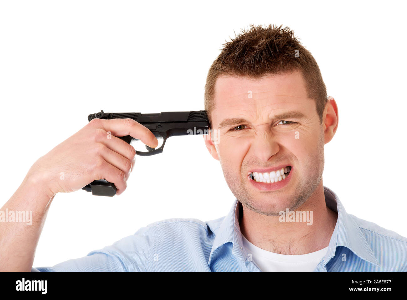 Man putting gun to head. He is depressed and frustrated and thinking of suicide. Stock Photo
