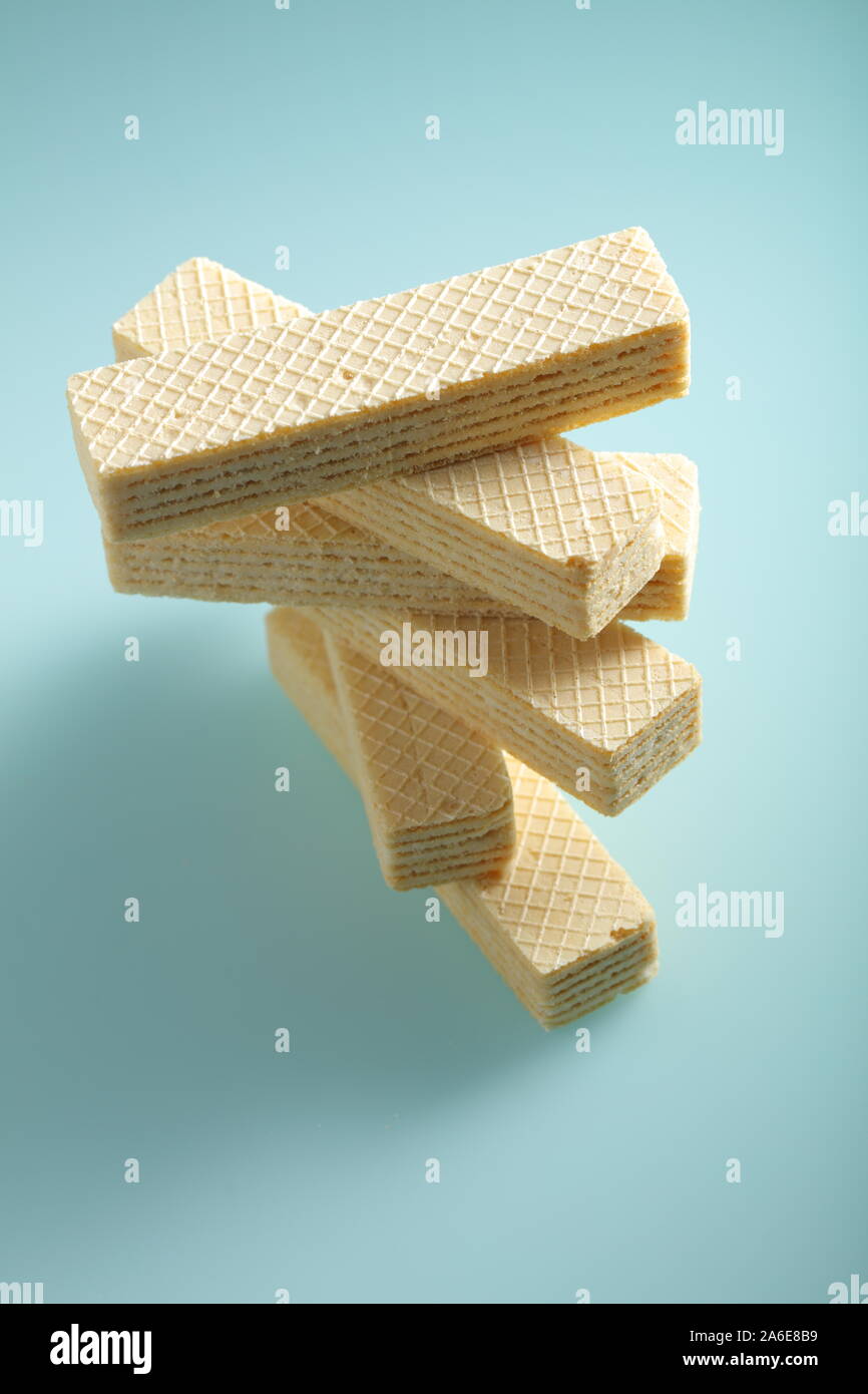 Stack of wafers against cyan background Stock Photo