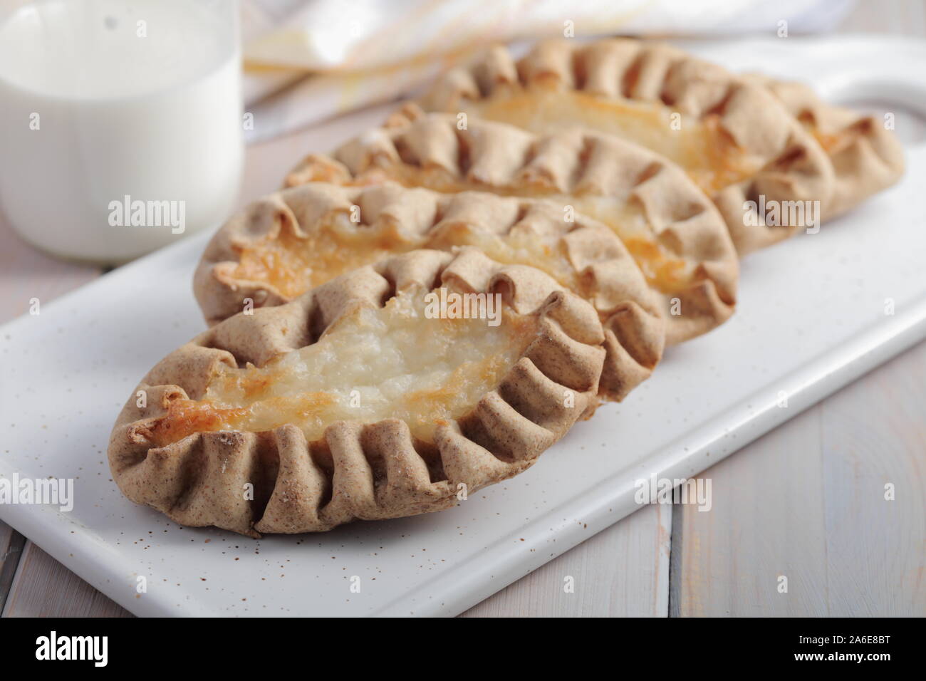 Karjalanpiirakat, Karelian pasties on a cutting board against eggs. Today it is a national dish in Finland Stock Photo