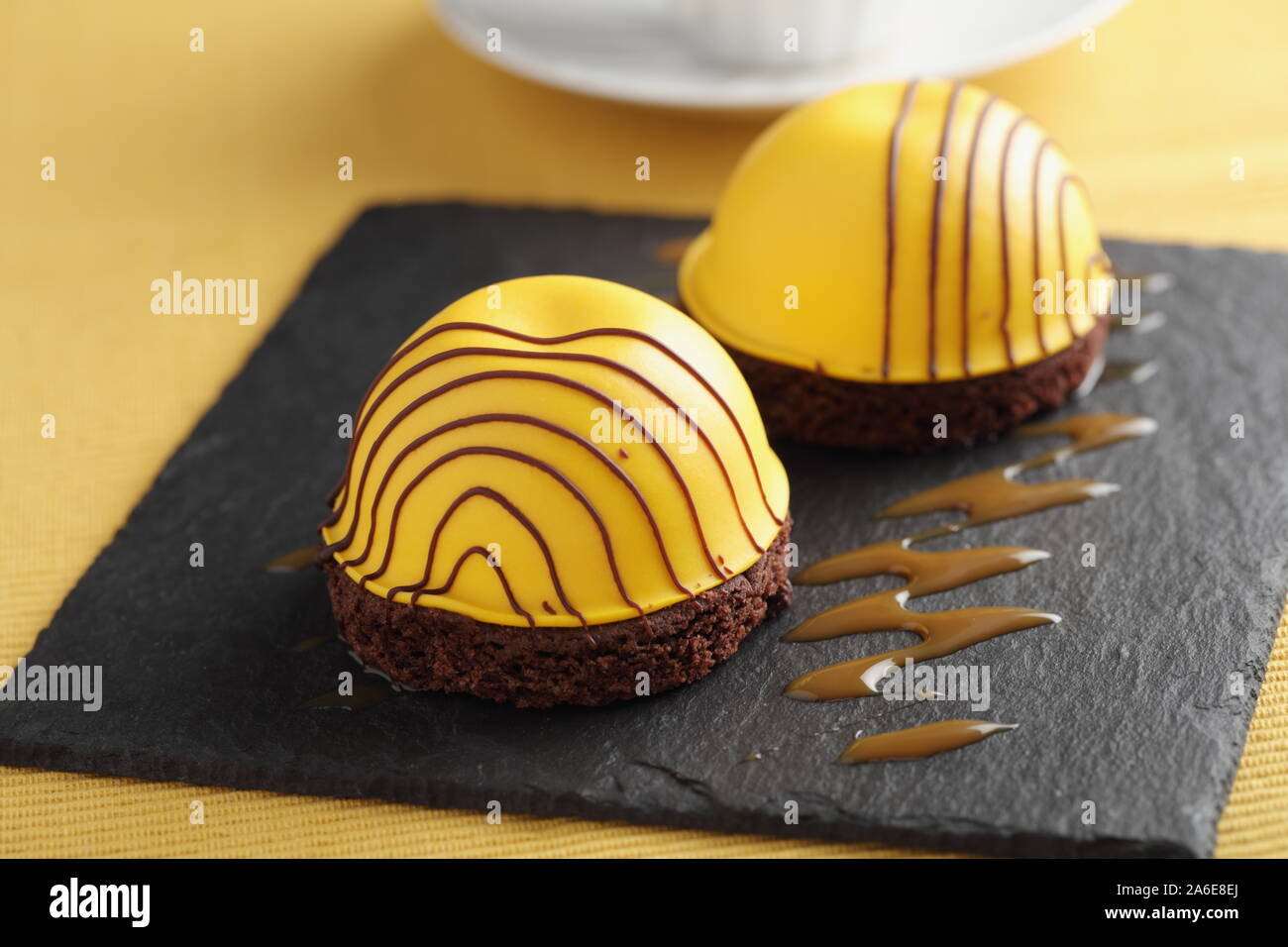 Swedish princess cake  with mango marshmallow on chocolate disk with chocolate icing Stock Photo