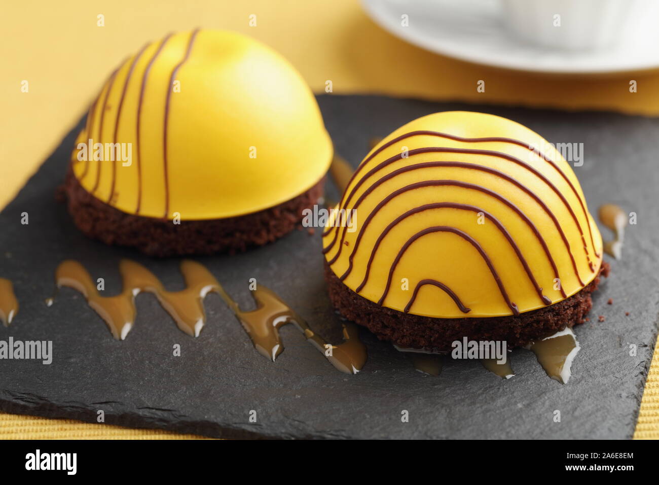 Swedish princess cake  with mango marshmallow on chocolate disk with chocolate icing Stock Photo