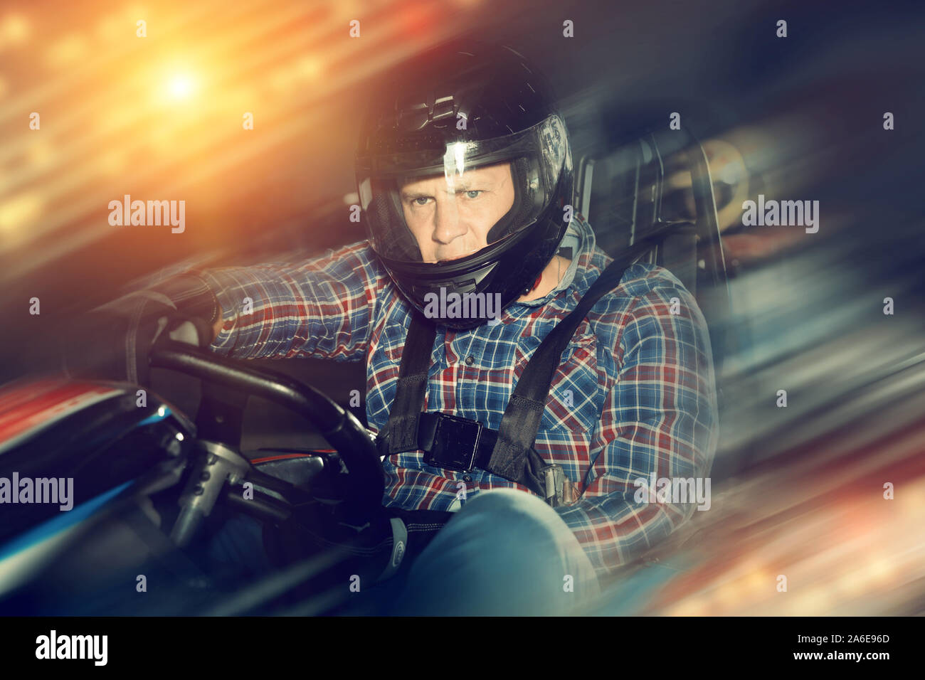 Portrait of happy man driving racing car at kart circuit Stock Photo ...