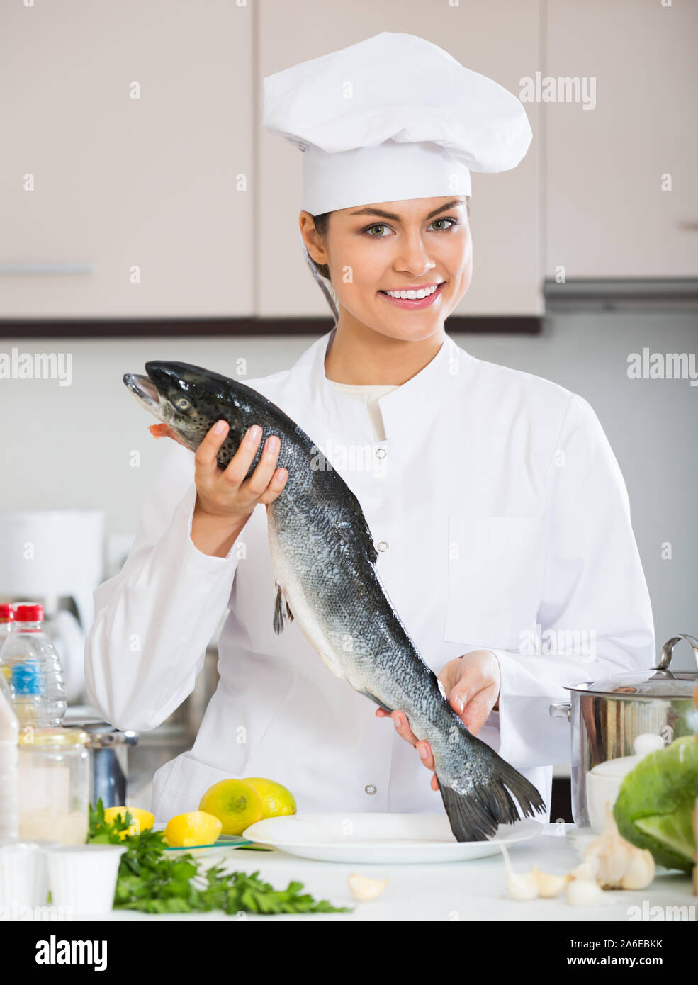 Chef holding rainbow trout in professional kitchen Stock Photo Alamy