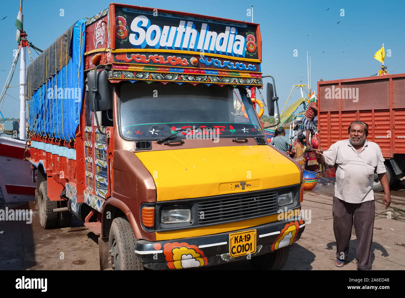 A man stands next to his truck in the Old Port, mainly used for fishing boats, in Mangalore, Karnataka, South India Stock Photo
