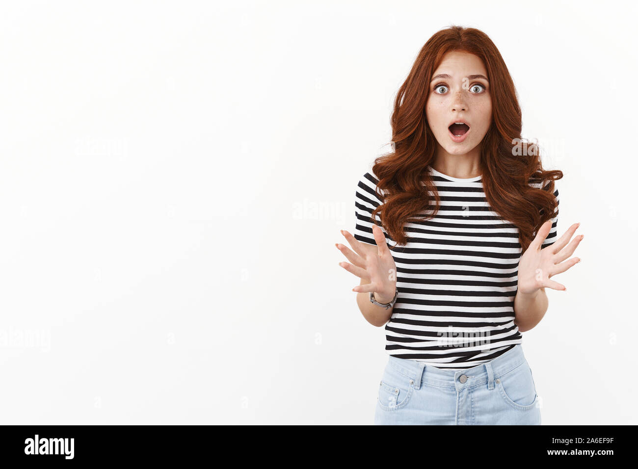 Excited and amazed nervous young redhead woman drop jaw, gasping with