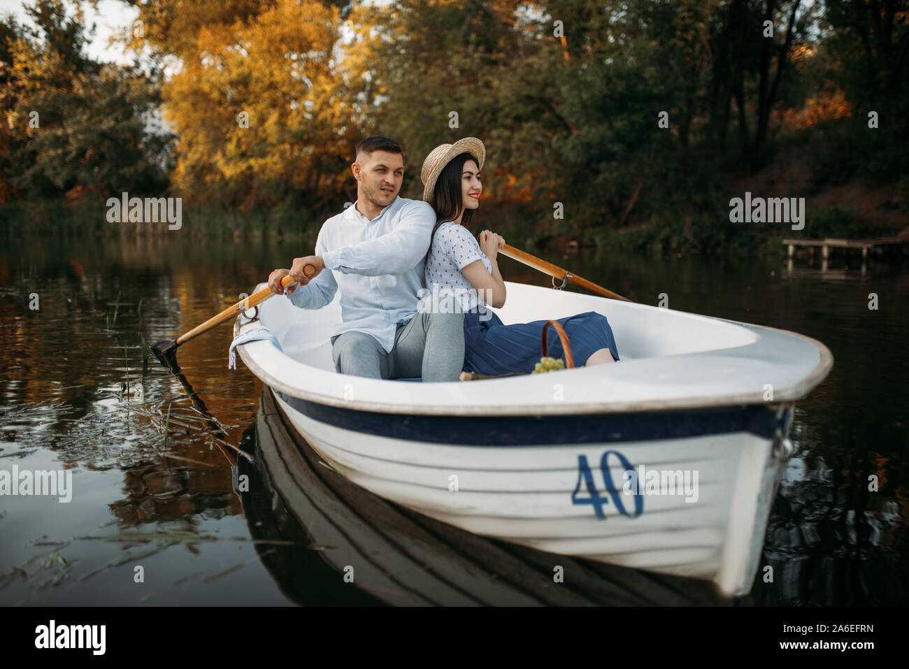 Love couple hugs in a boat on quiet lake Stock Photo - Alamy