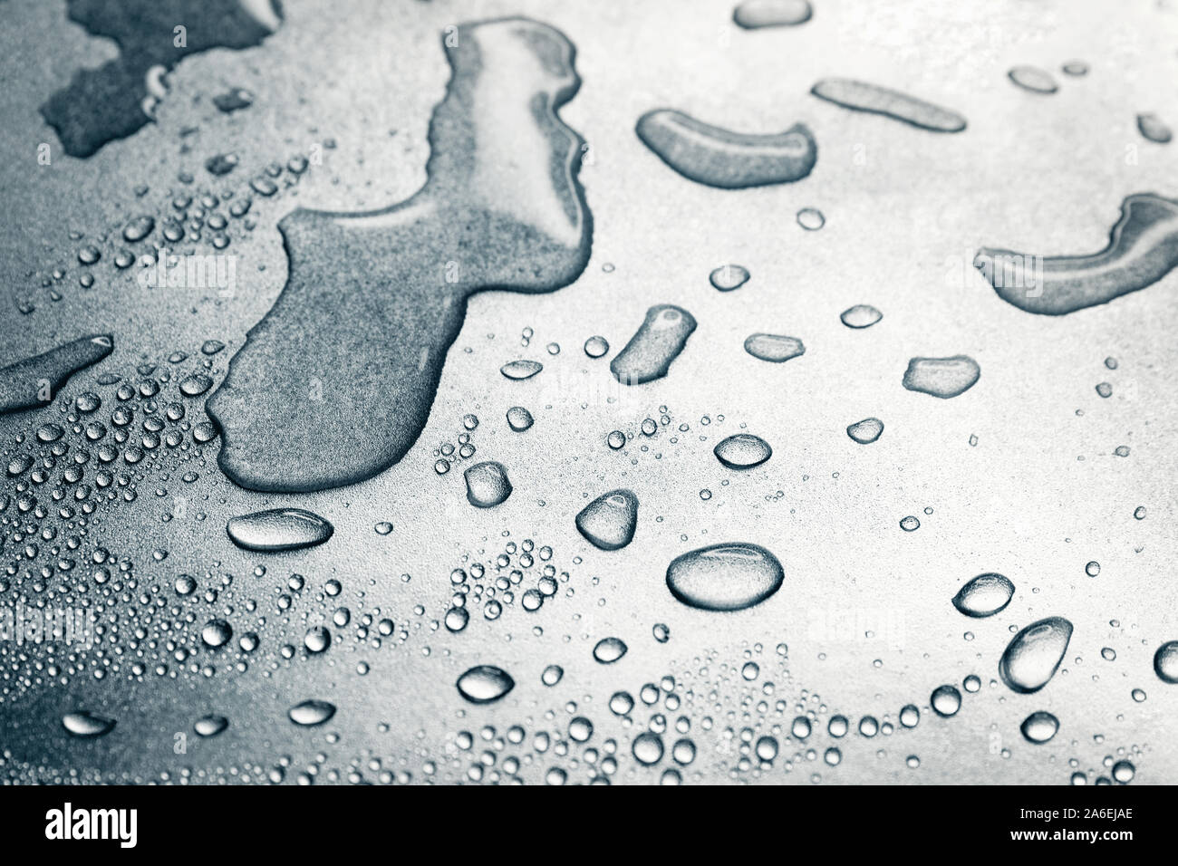 Water drops on rough silvery background, close-up Stock Photo