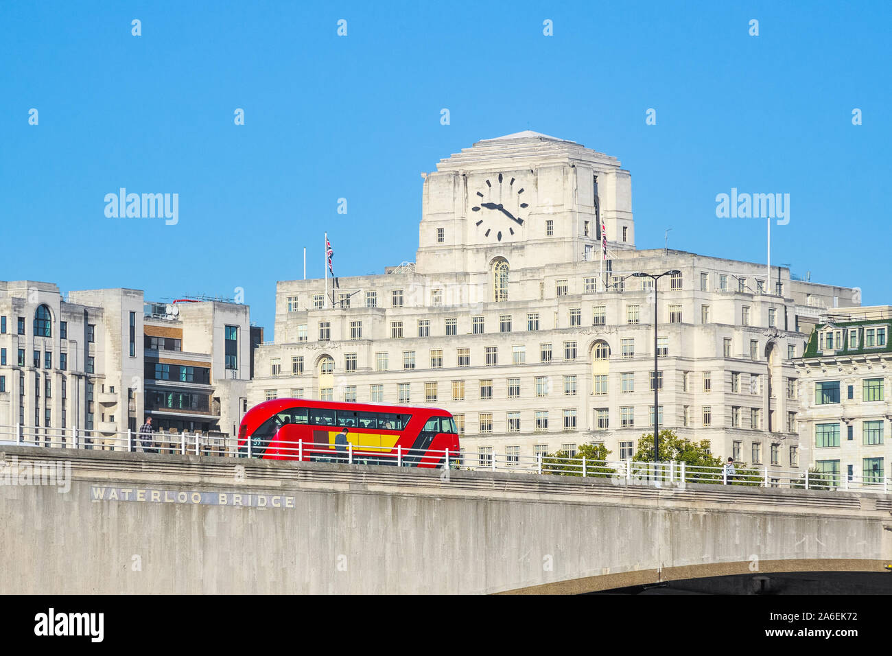 Waterloo Bridge with a passing bus and facade of Shell Mex House in the background in London Stock Photo