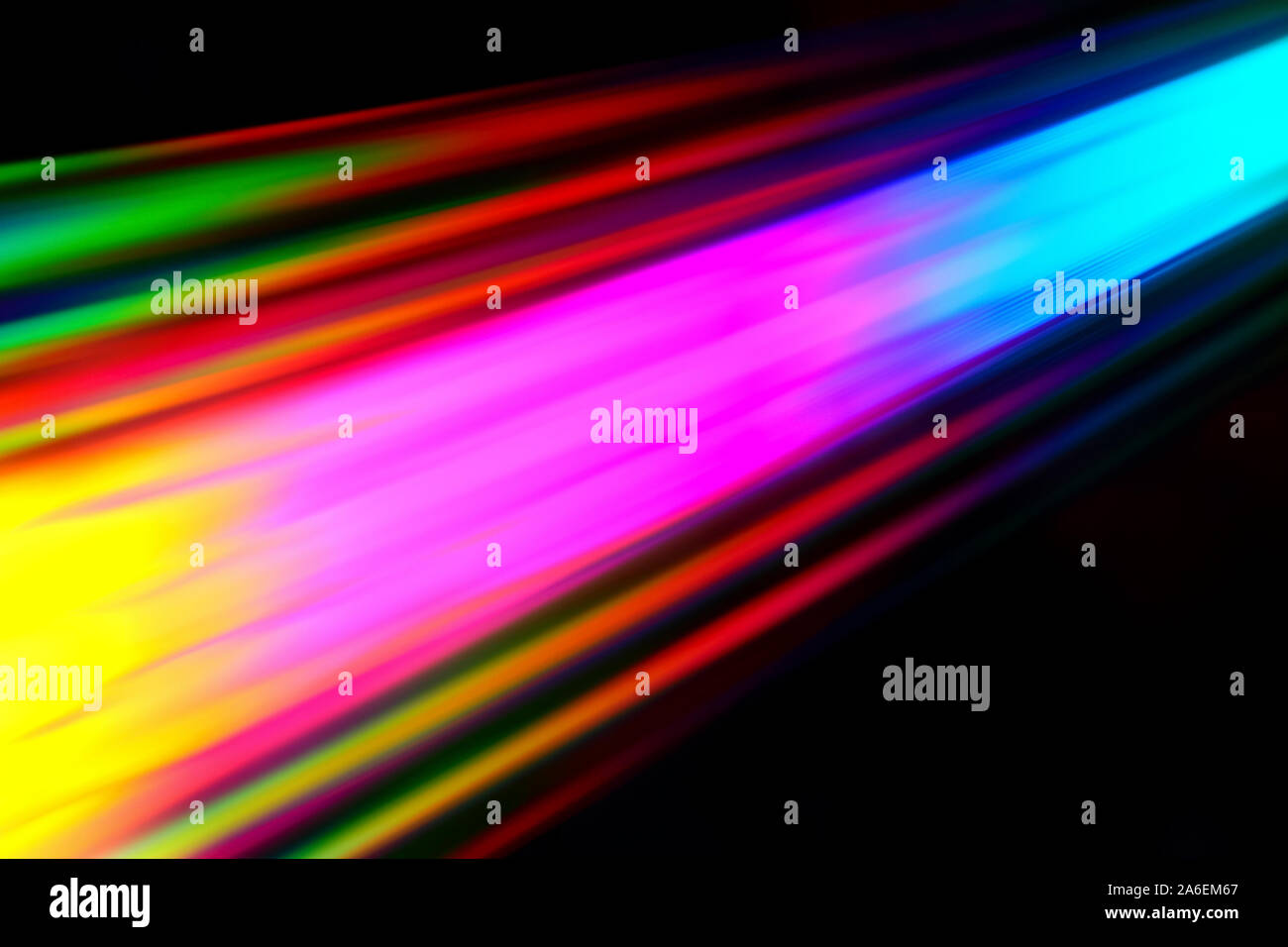 Colourfull burst of prismatic light creating lines of blured motion against a black background Stock Photo