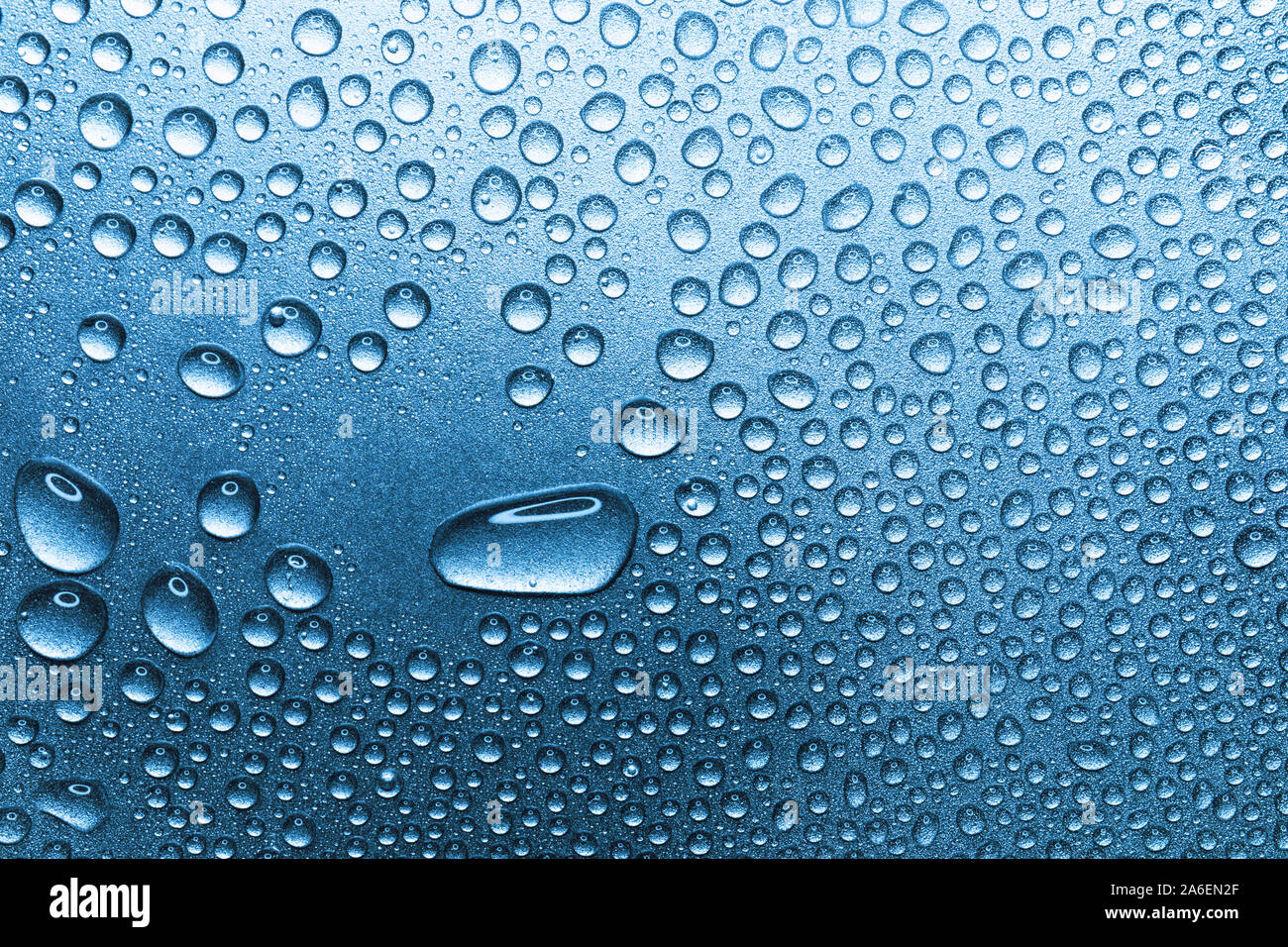 Water drops on rough silvery background, close-up Stock Photo