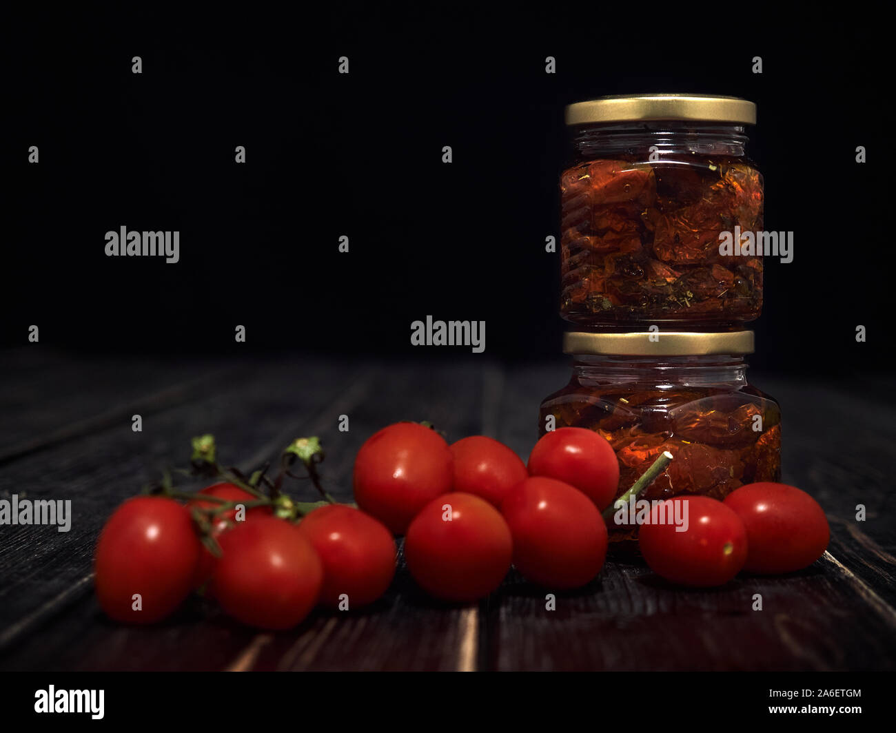 Sundried red tomatoes are packed in 0.25 liter glass jars and drenched