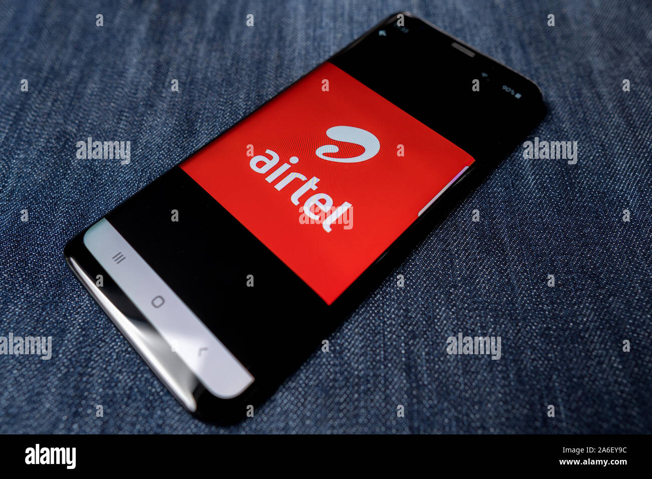 Odessa, Ukraine - October 26, 2019: Airtel mobile operator app. Airtel mobile operator logo visible on smartphone screen. Denim background. Soft focus Stock Photo