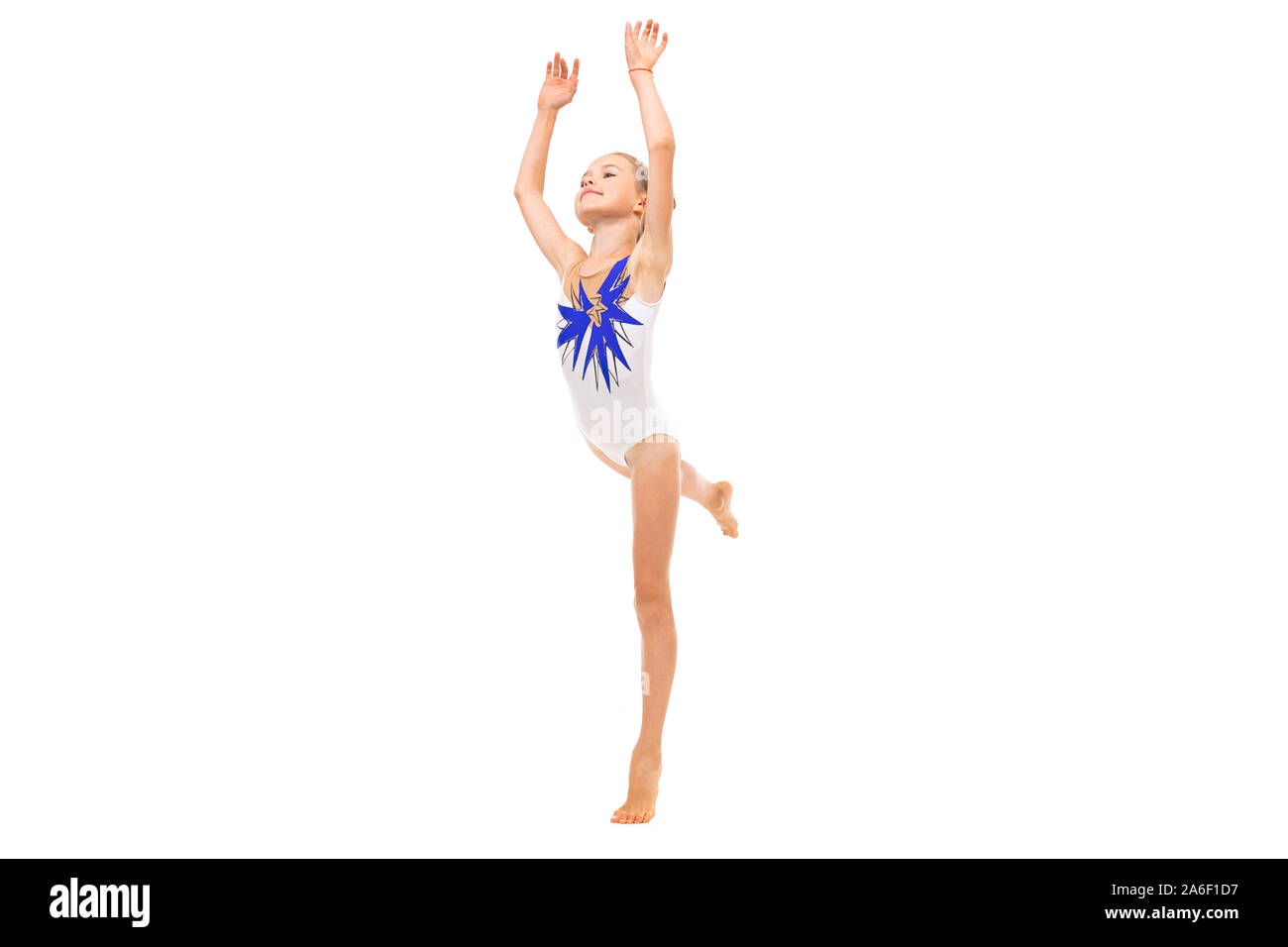 girl gymnast in white trico in full height performs in a white jump isolated on a white background Stock Photo