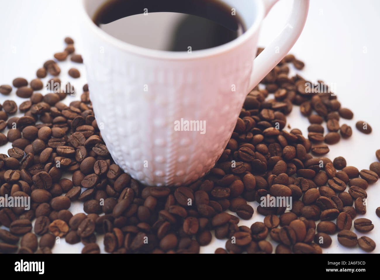 White coffee cup and coffee beans on white background Stock Photo - Alamy