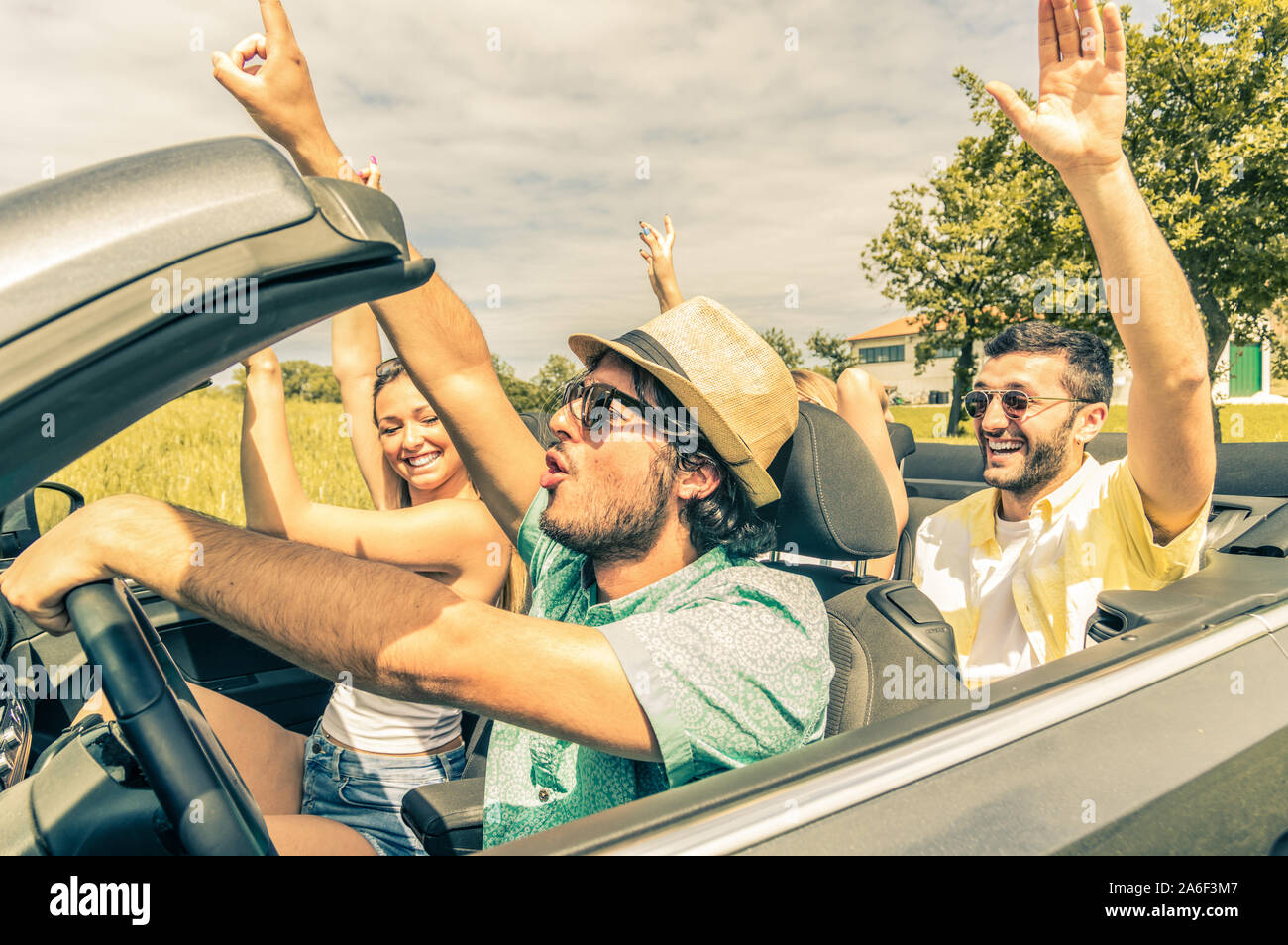 Group of friends having fun at car trip. Four caucasian people on a ...