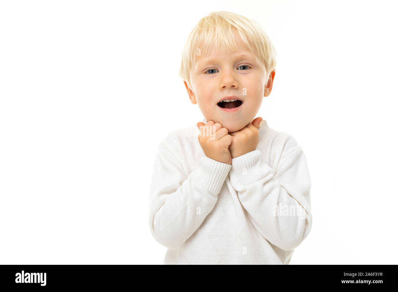 Little boy with short blonde hair, blue eyes, cute appearance, in white  jacket, light blue pants, stands and is surprised Stock Photo - Alamy