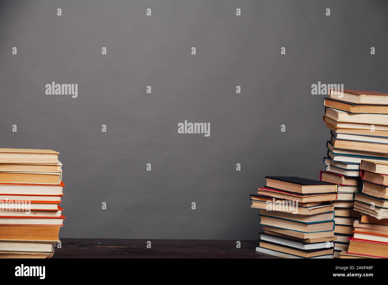 a lot of different educational books on a gray background Stock Photo