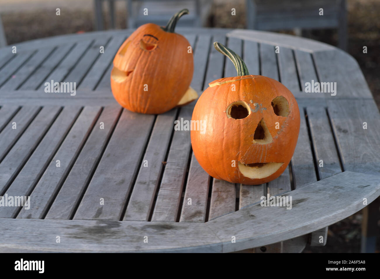 Carved Pumpkins, Smiling, on a Table Out of Doors Facing and Side