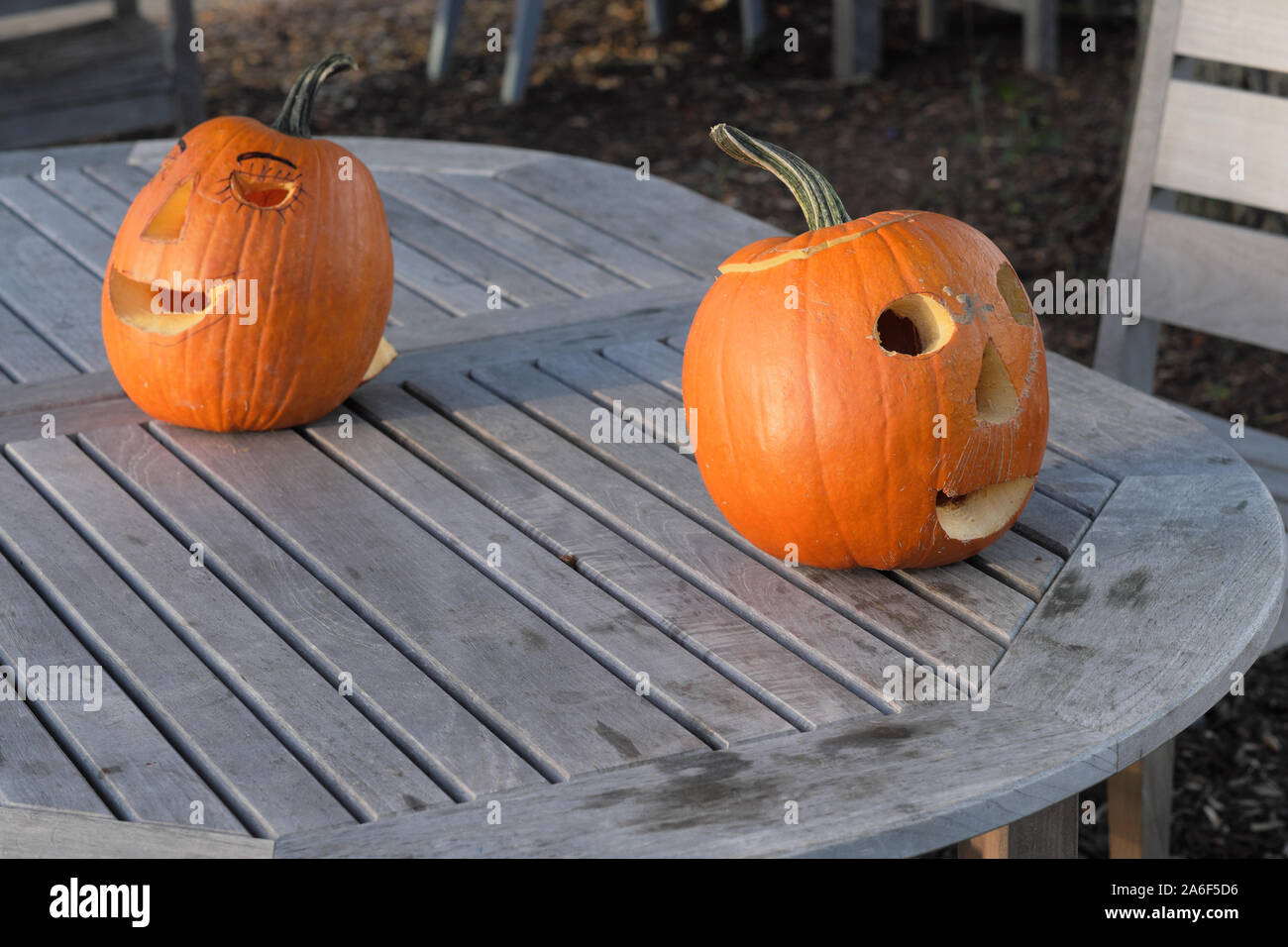 Carved Pumpkins, Smiling, on a Table Out of Doors Facing and Side