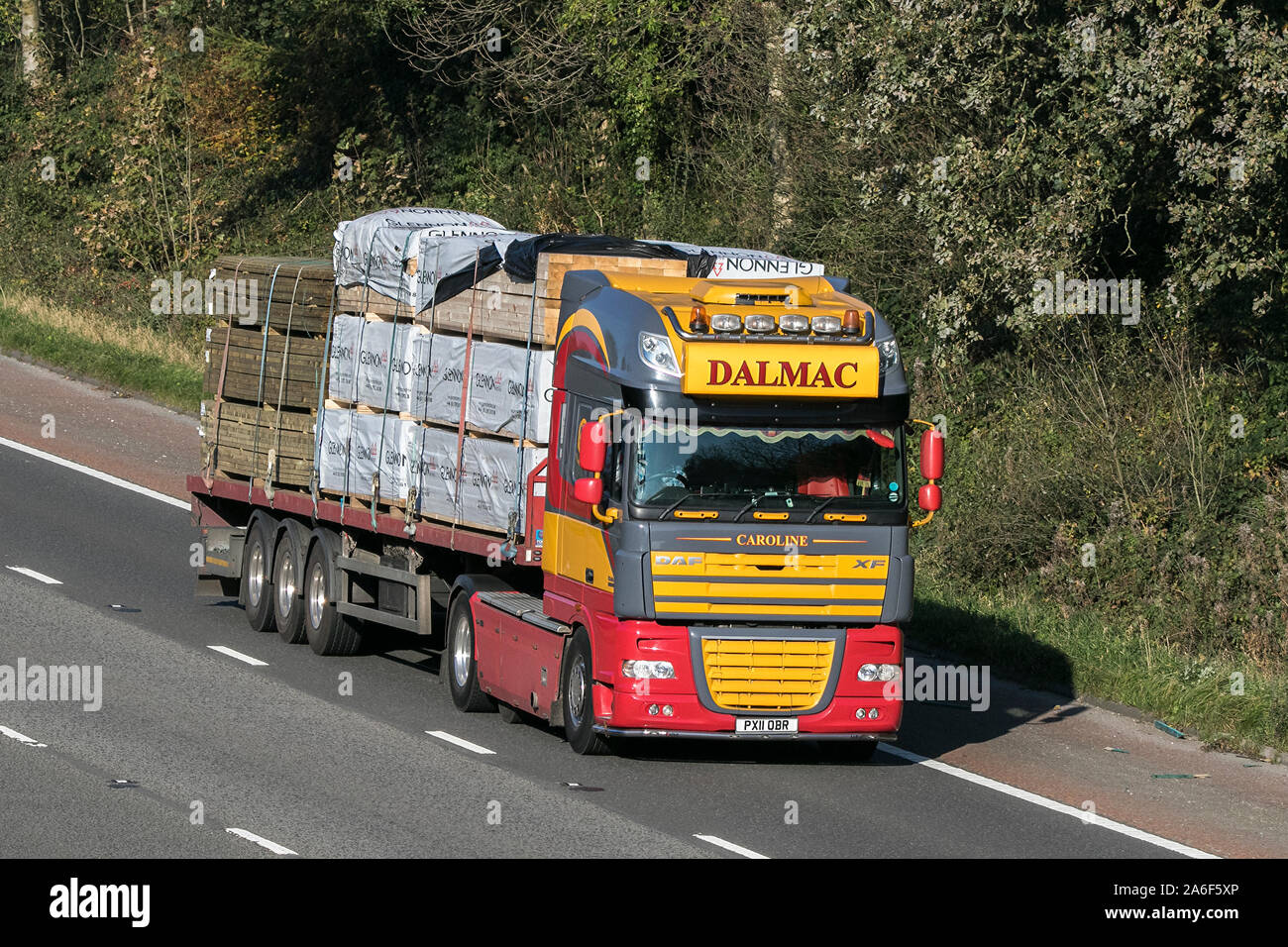 A Dalmac transport articulated DAF XF semi truck traveling on the M6 motorway near Preston in Lancashire, UK Stock Photo