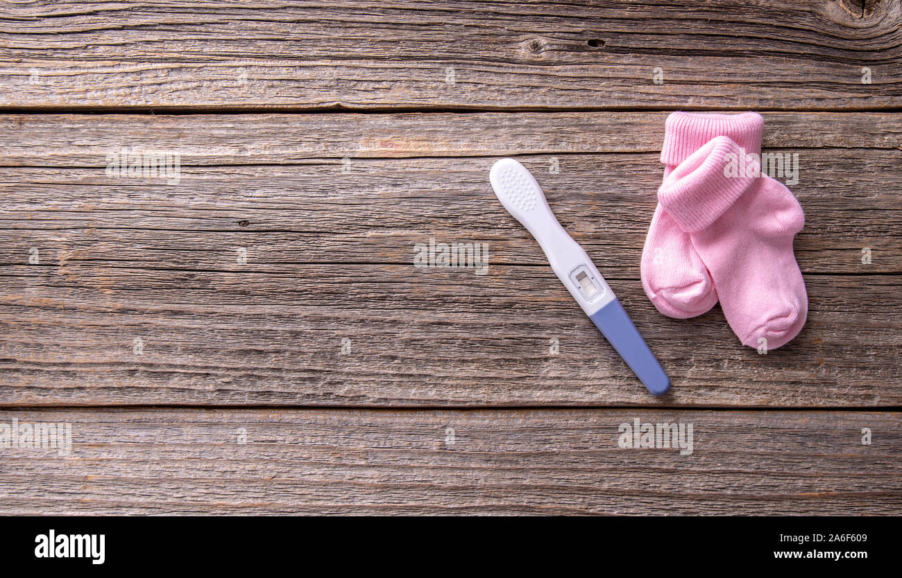 Pregnancy test as a still life on a wooden background. Stock Photo