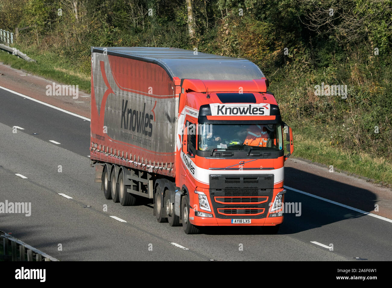 A Knowles transport curtain sided articulated Volvo Globetrotter semi truck traveling on the M6 motorway near Preston in Lancashire, UK Stock Photo