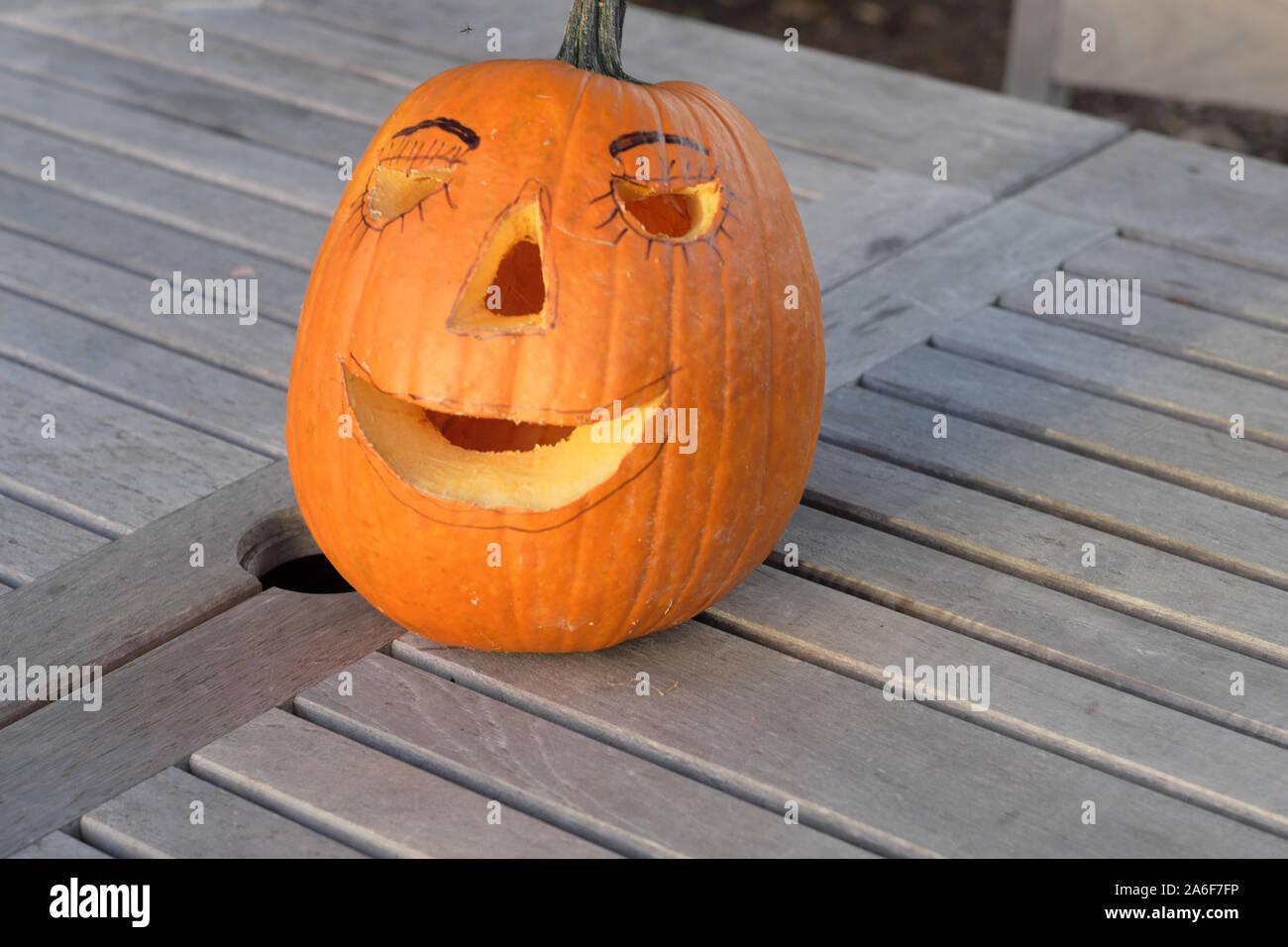 Carved Pumpkins, Smiling, on a Table Out of Doors Facing and Side