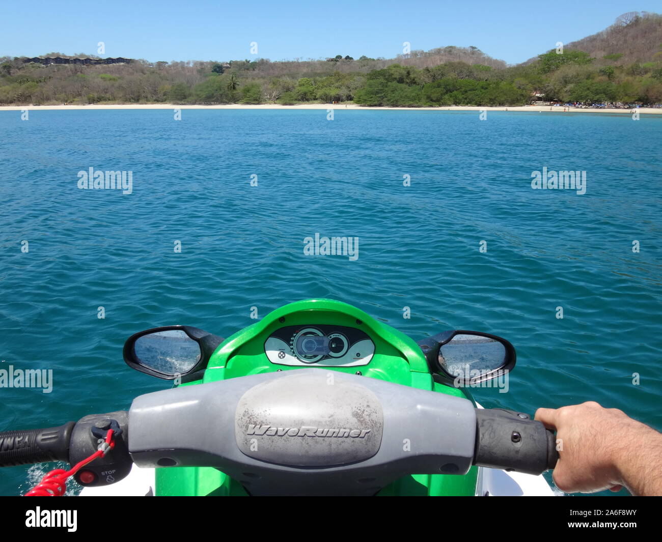 PAPAGAYO, COSTA RICA -20 MAR 2019- Driving a jet ski watercraft on the Pacific Ocean in Costa Rica. Jet skis, first introduced in 1972, are popular re Stock Photo