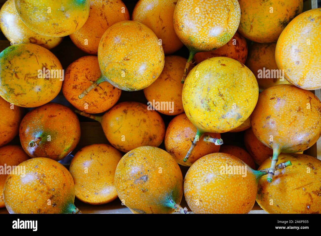 Basket of colorful ripe passion fruits at a food market Stock Photo