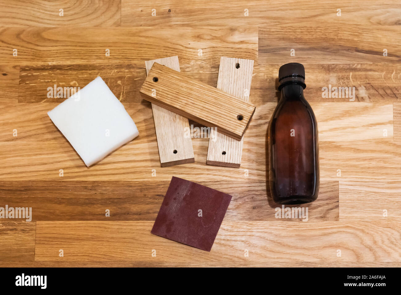 Wood furniture care kit on the Oak oiled wood plank table. Sandpaper