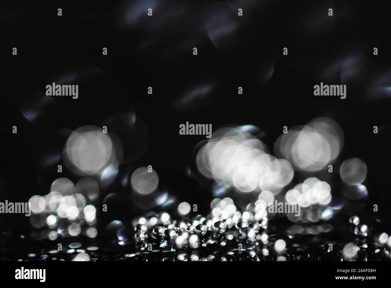 abstract dark background with silver small balls and bokeh effect, template image with copy space Stock Photo