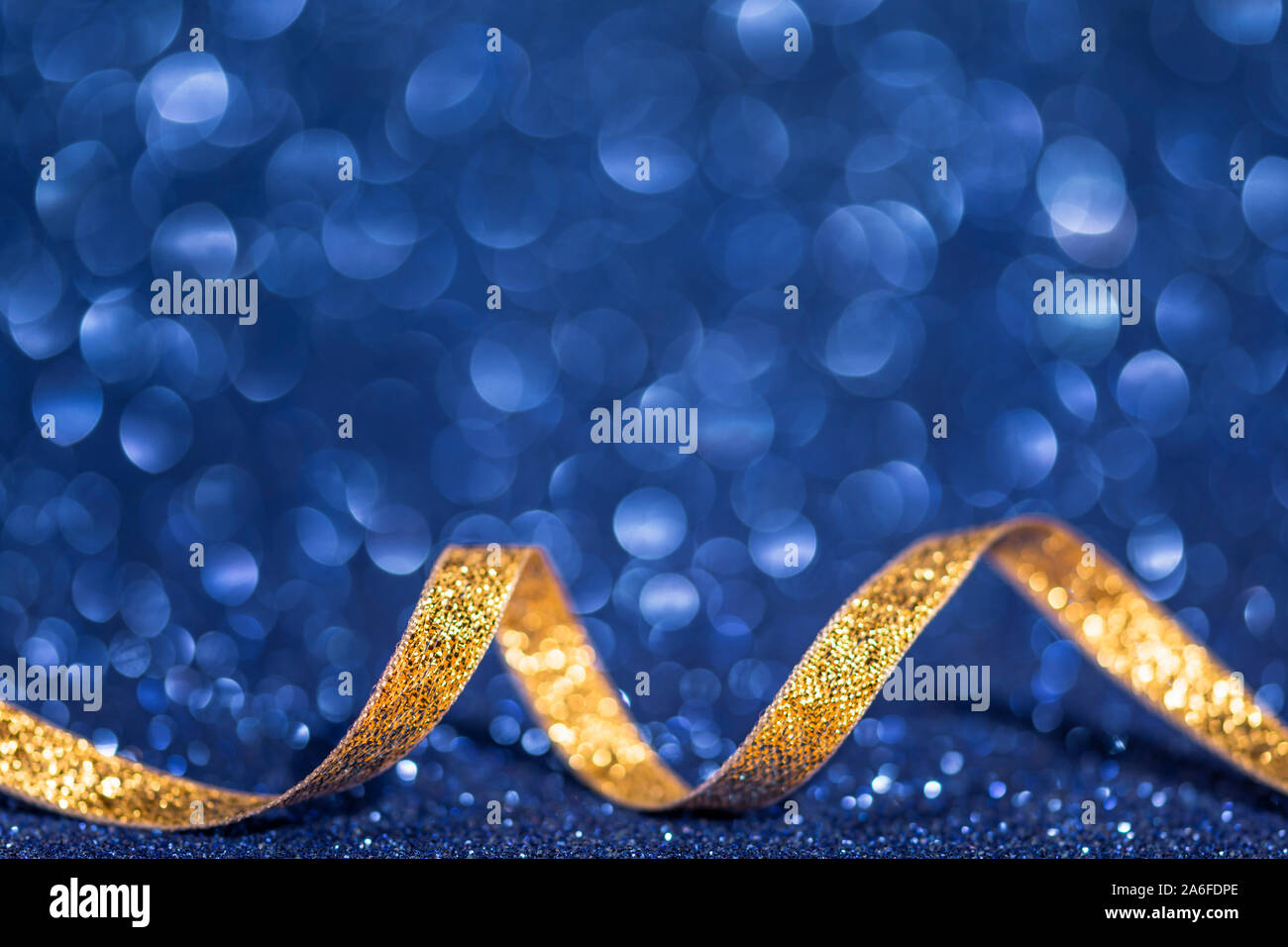 christmas background with golden ribbon and blue bokeh Stock Photo - Alamy