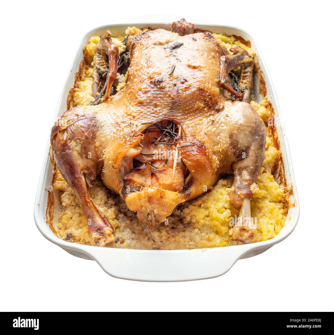 baked duck stuffed with apples and millet porridge in ceramic pan