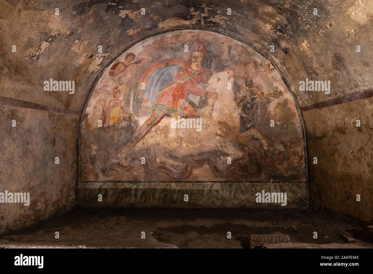 Capua, Caserta, Italy, October 2019: Fresco Representing the Mithras divinity was killing a white bull, inside of the Mithraeum of Ancient Capua. Is one of the most important of the Roman empire.  Stock Photo