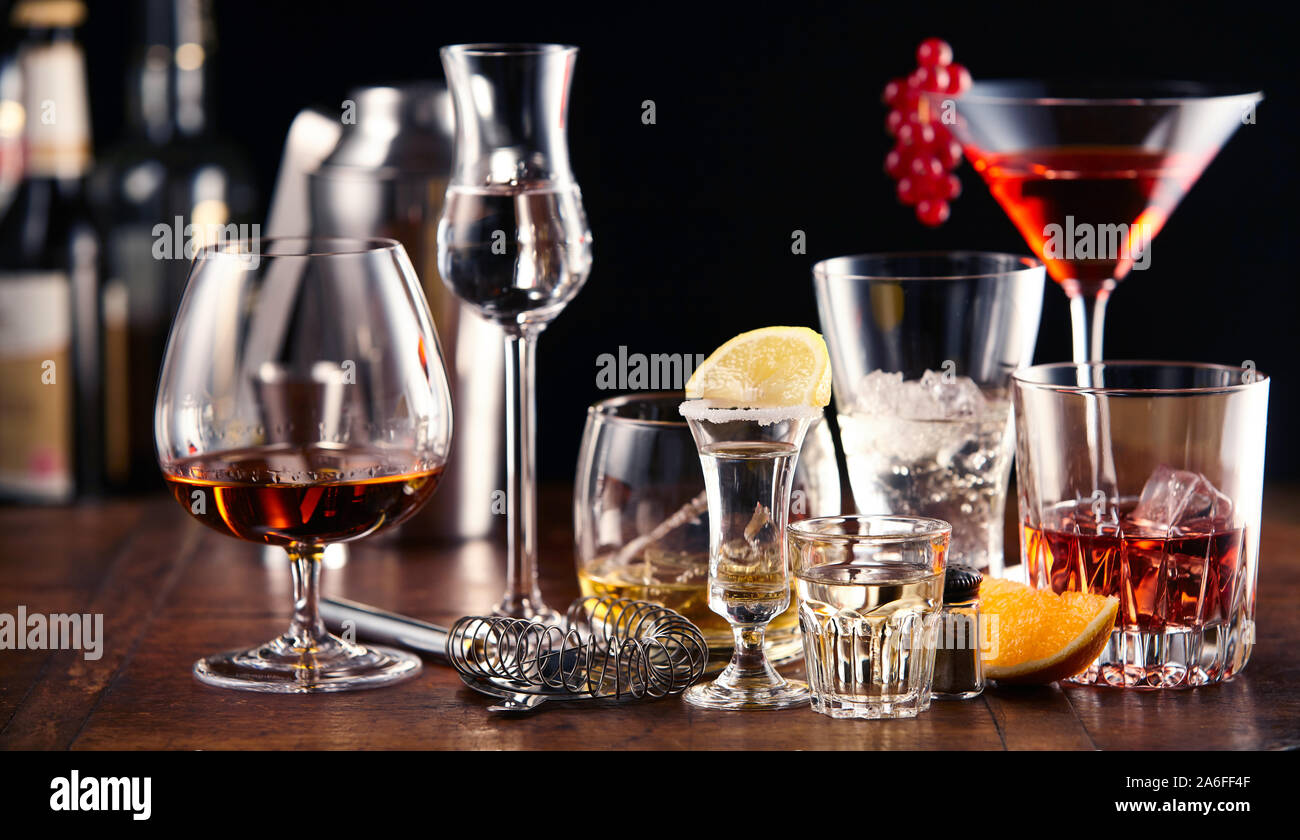 Large assortment of alcoholic beverages and cocktails served in