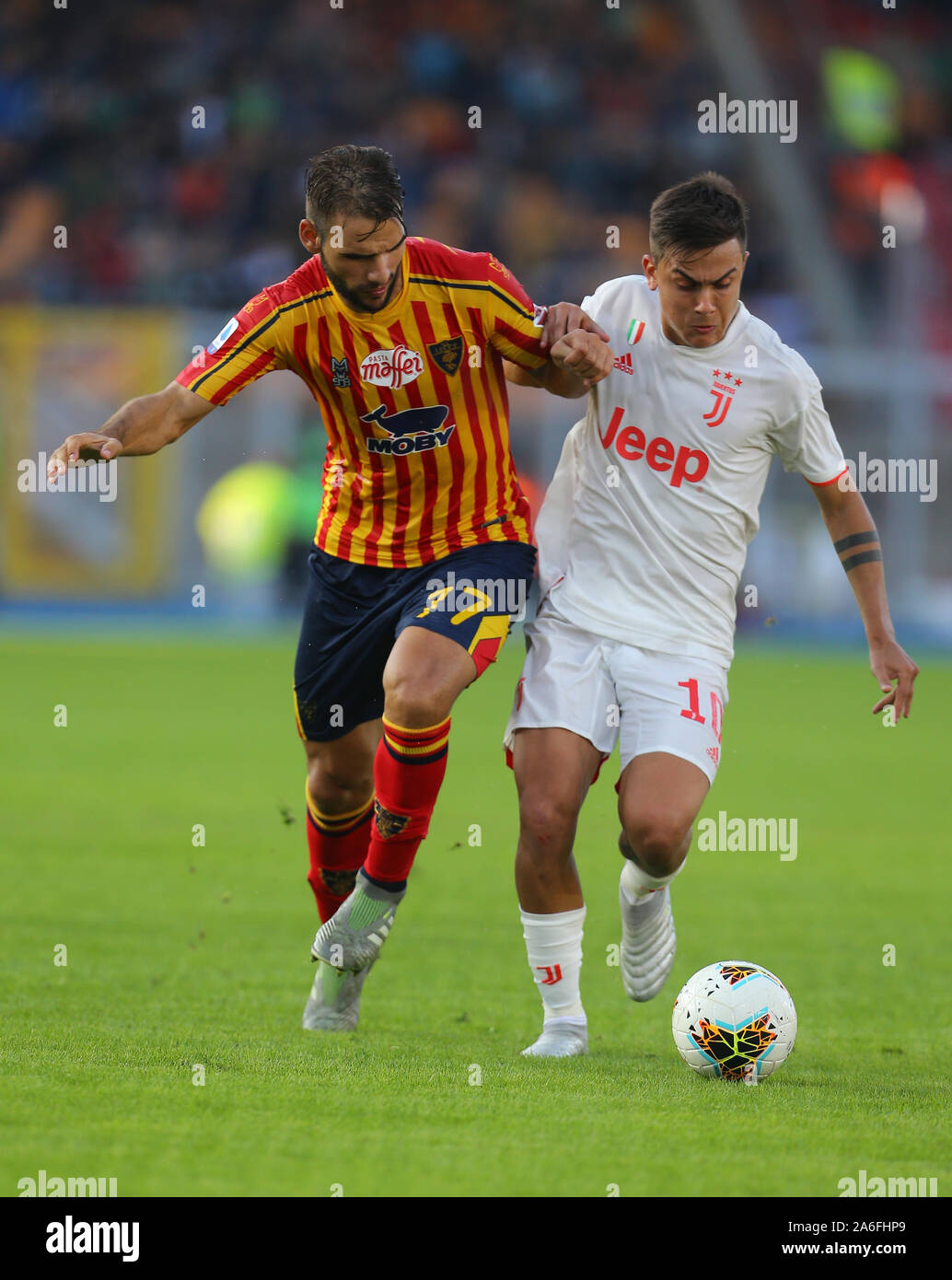 Lecce, Italy. 26th October 2019. Juventus' Argentinian forward Paulo Dybala (R) fights for the ball with Lecce's Greek midfielder Panagiotis Tachtsidis during the Italian Serie A football match US Lecce vs Juventus FC on October 26 2019 at the Via del Mare-Ettore Giardiniero Stadium. Lecce drew with Juventus 1-1. Credit: Independent Photo Agency Srl/Alamy Live News Stock Photo