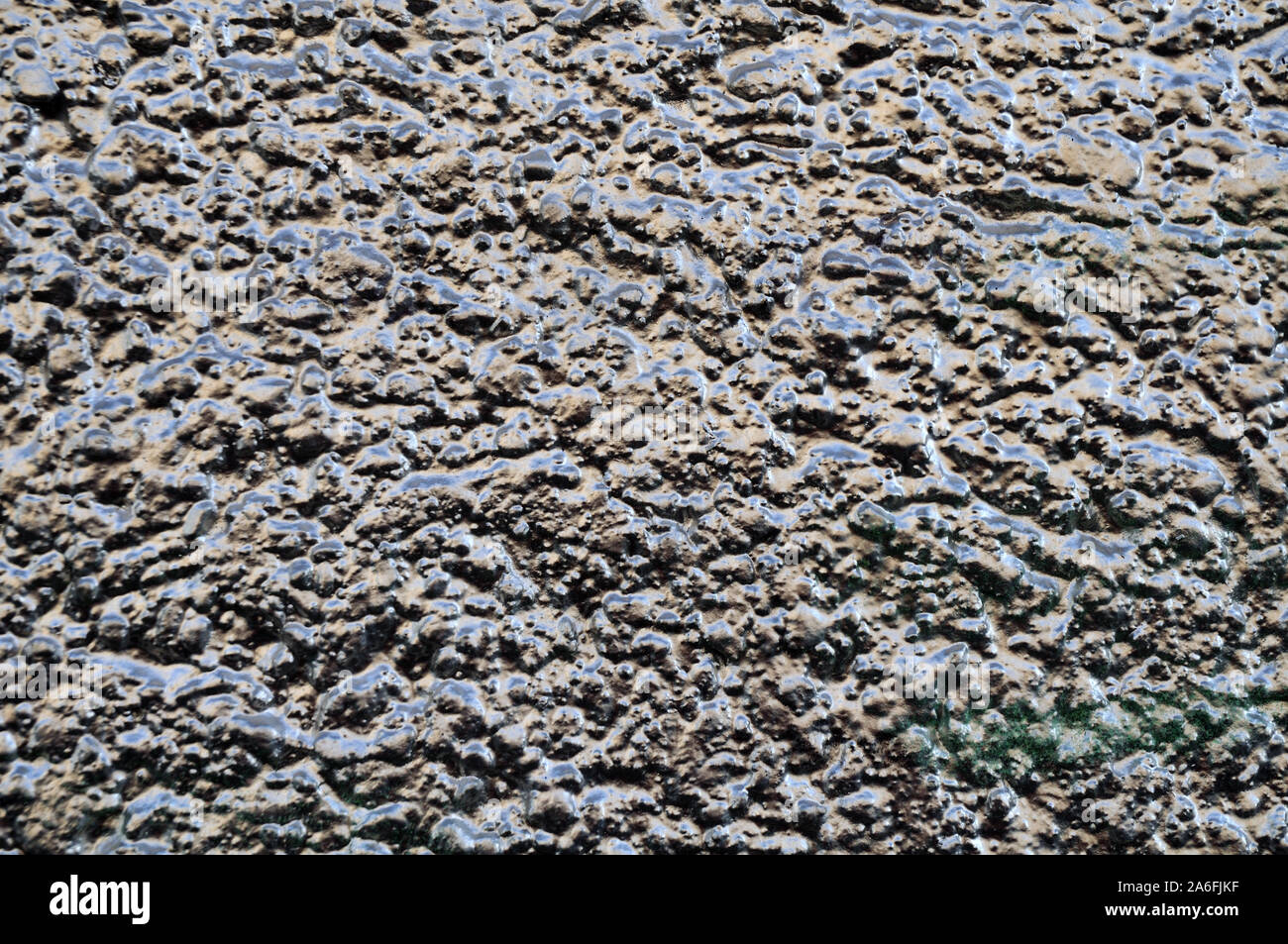 facade with plastered wall painted with silver color showing metallic glitter Stock Photo